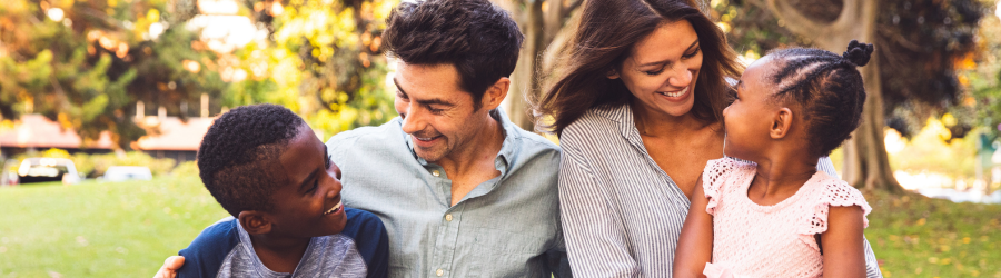 parents with adoptive children at the park