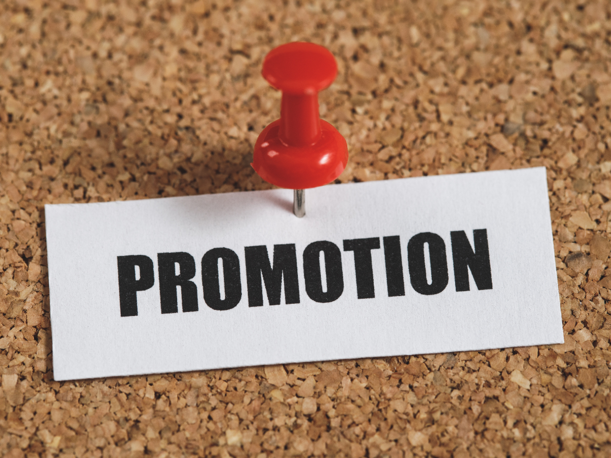 "promotion" word pinned on a board